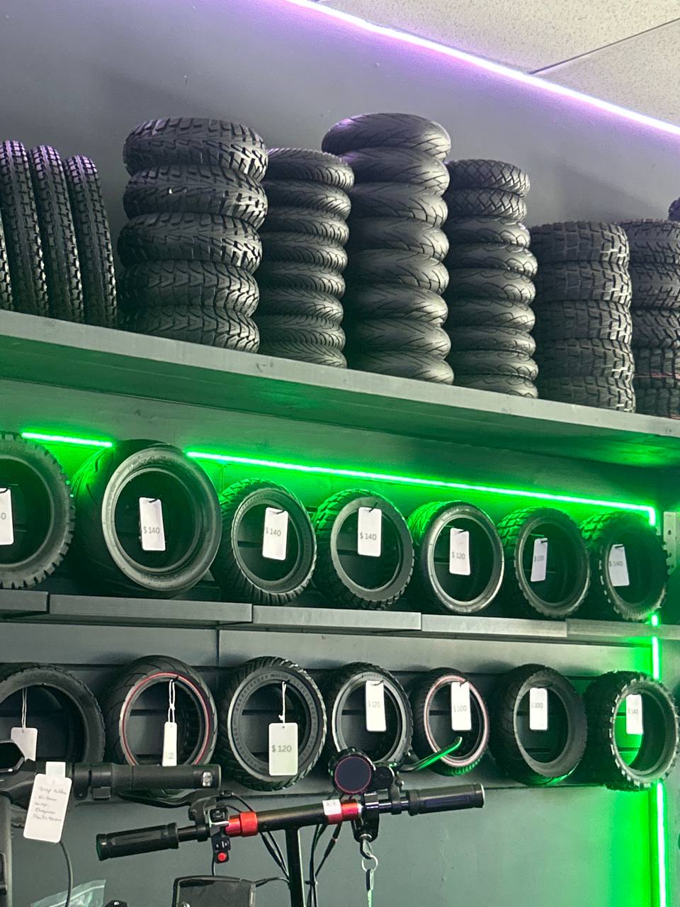 Electric scooter tire inventory with green LED lighting at Electric Scooter Doctors